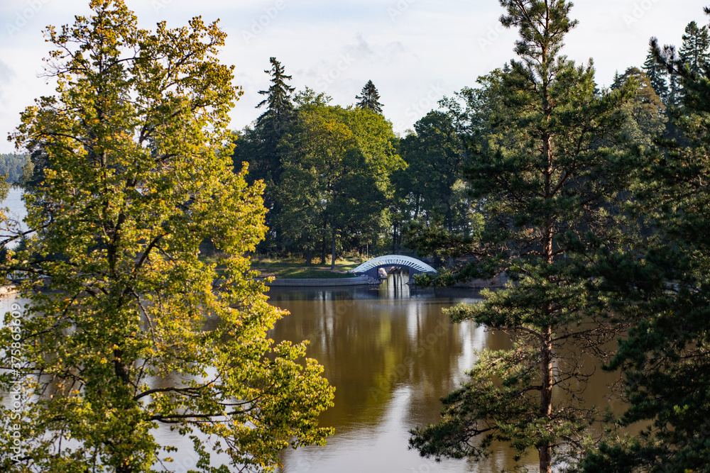 Autumn landscape with lakes and white bridge Autumn landscape with lakes and white bridge