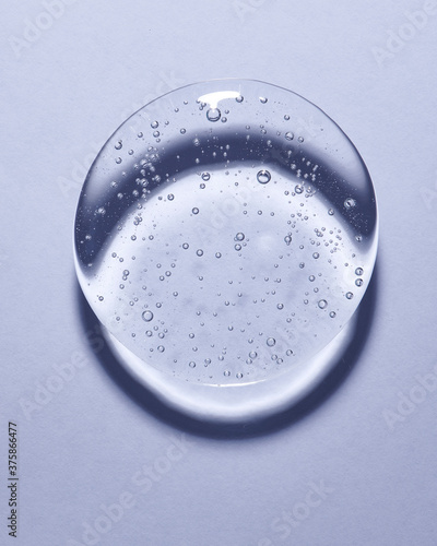 Single blob of transparent glycerin or gel. Glossy texture with tiny bubbles. 