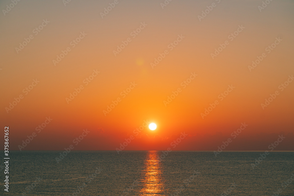 Rising sun from the horizon over the sea