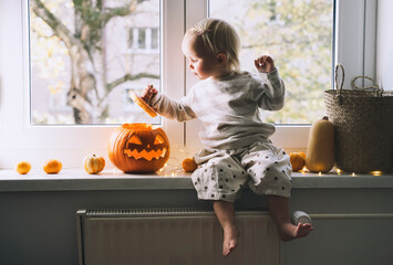 Happy family preparing for Halloween at home together.