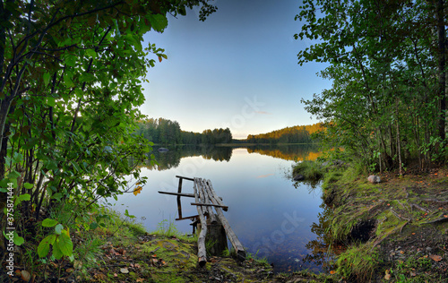 In the evening on the shore of a quiet, forest lake