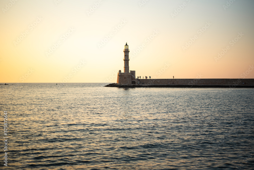 Lighthouse at the end of the pier. Chania, Crete, Greece. Photo taken during sunset