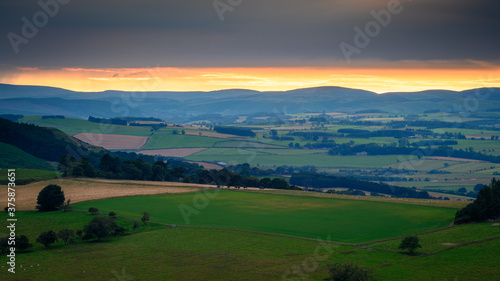 Sunset over the Cheviot Hills, viewed from Simonside Hills near Rothbury in Northumberland National Park across Coquetdale photo