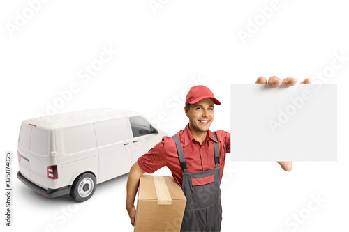 Male courier with a van holding a cardboard box and showing a blank card to the camera © Ljupco Smokovski