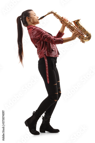 Obraz na plátně Full length profile shot of a female saxophonist with long black hair playing sa