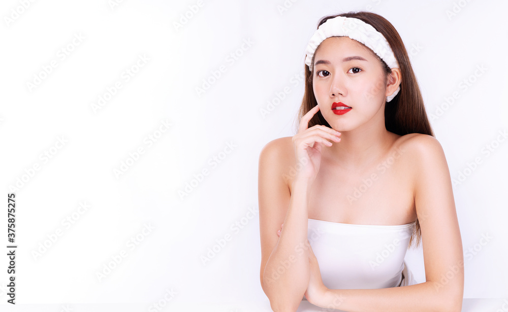 Charming young woman wear headband touching her face with clean fresh body. Teenager before bathing while looking at camera over isolated white background. Beauty cosmetics and healthy skin concept. Charming young woman wear headband touching her face with clean fresh body. Teenager before bathing while looking at camera over isolated white background. Beauty cosmetics and healthy skin concept.