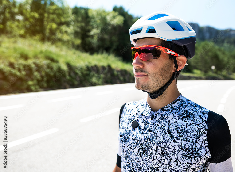 Portrait of young cyclist on the road.