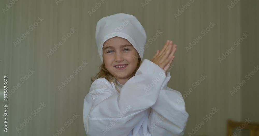 Cute Little Kid Girl Wear Medical Uniform Hands Applauding Medical Staff at Home. Portrait of Creative Child Smiling Girl Wearing Doctor Uniform With Stethoscope Celebrating Success Applause Clapping. Cute Little Kid Girl Wear Medical Uniform Hands Applauding Medical Staff at Home. Portrait of Creative Child Smiling Girl Wearing Doctor Uniform With Stethoscope Celebrating Success Applause Clapping.