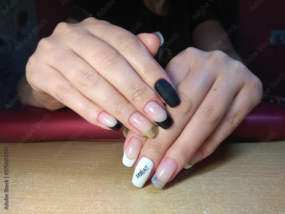The manicurist excellently made her work a beautiful manicure with a polish gel on her hands and the client is happy

