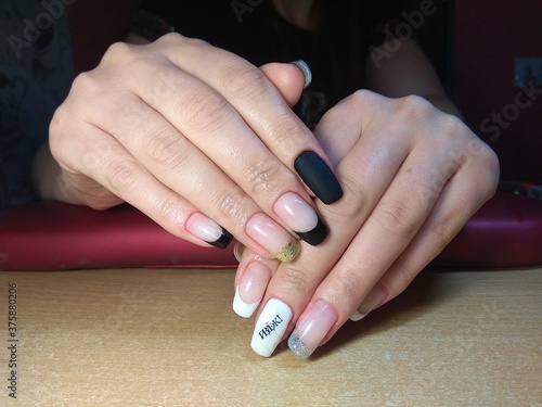 The manicurist excellently made her work a beautiful manicure with a polish gel on her hands and the client is happy 
