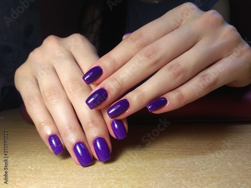 The manicurist excellently made her work a beautiful manicure with a polish gel on her hands and the client is happy 