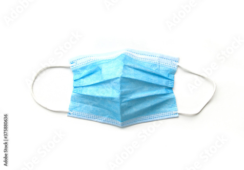 Blue medical face mask isolated on white background. Covid-19 Coronavirus prevention concept. Protective surgical mask with rubber ear straps.