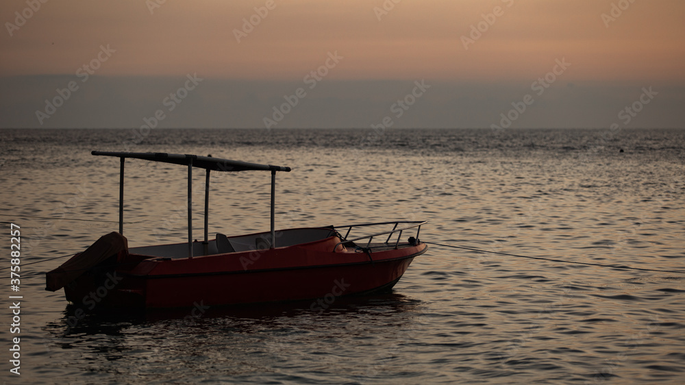 small boat floats on the water against the background of mountains small boat floats on the water against the background of mountains