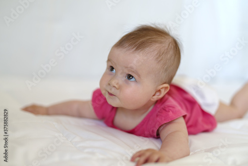 Five month baby girl in bed