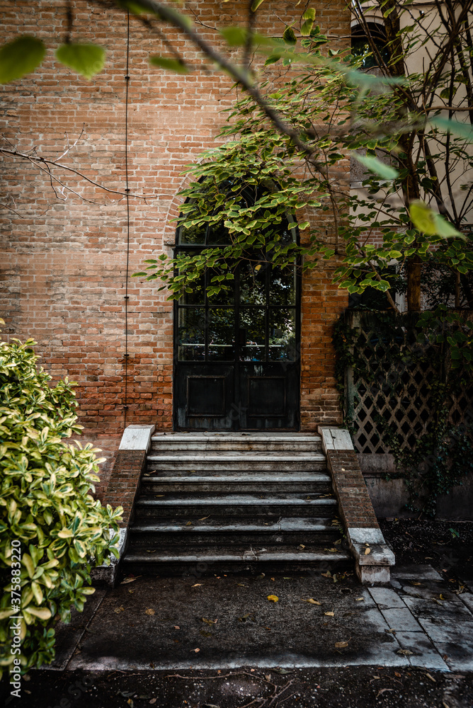 Iron window door and brick wall in an old building