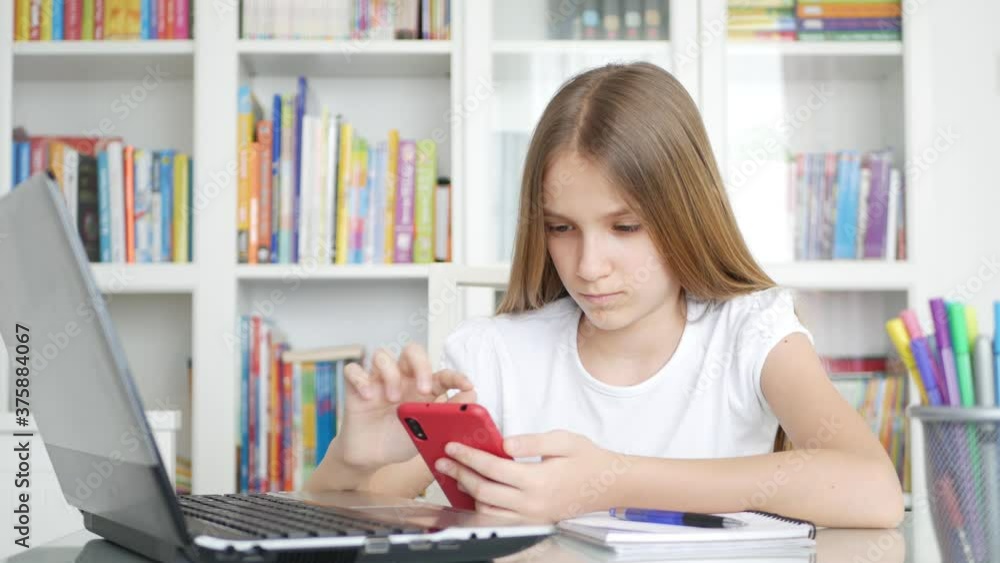 Kid Using Smartphone Studying in Video Conferencing, Child Learning, Writing in Library, Schoolgirl Chatting, Online Education Kid Using Smartphone Studying in Video Conferencing, Child Learning, Writing in Library, Schoolgirl Chatting, Online Education