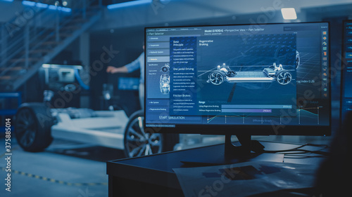 Auto Industry Design Facility Screens Show 3D Cad Software: Electric Vehicle Platform Chassis Prototype and Concept with Wheels, Engine and Battery. Engineers and Developers Application