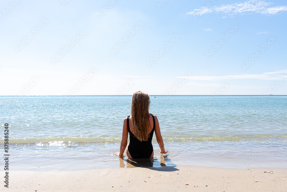 Beautiful girl on the beach. Happy carefree young woman enjoying the sea