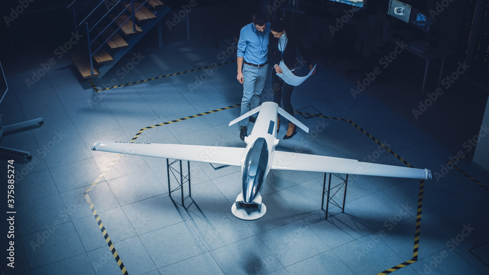 Meeting of Aerospace Engineers Work On Unmanned Aerial Vehicle / Drone  Prototype. Aviation Experts have Discussion. Industrial Facility with  Aircraft Capable of GPS Surveillance and Military Missions Photos | Adobe  Stock