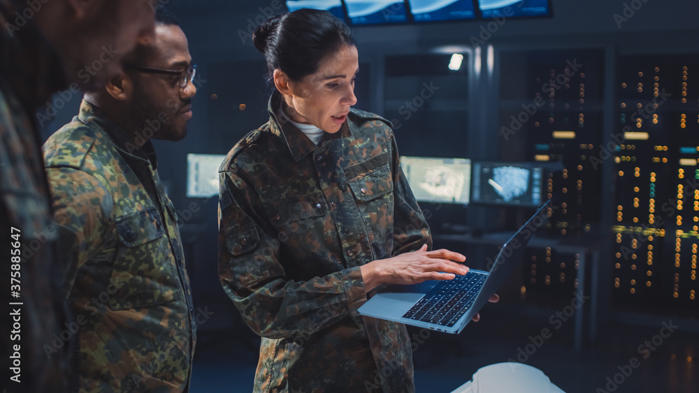 International Team of Military Personnel Have Meeting in Top Secret Facility, Female Leader Holds Laptop Computer Talks with Male Specialist. People in Uniform on Strategic Army Meeting - obrazy, fototapety, plakaty 
