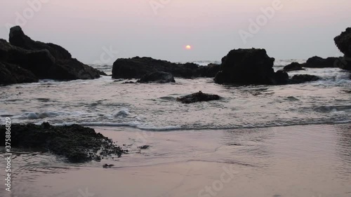 Tropical ocean waves movement at sunset.