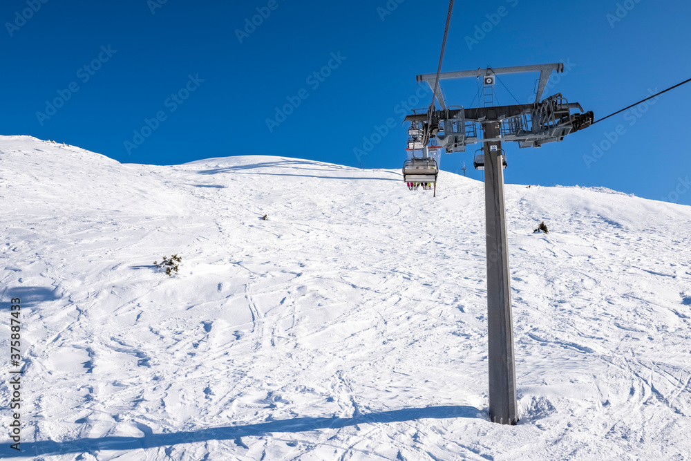 Gondola lift on the snowy slopes of the Brenta Dolomites - Alps Gondola lift on the snowy slopes of the Brenta Dolomites - Alps