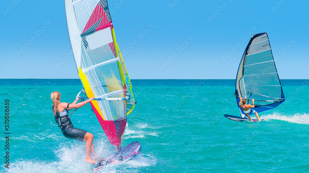 Beautiful cloudy sky with windsurfer surfing the wind on waves in Alacati - Cesme, Turkey 