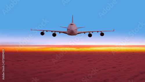 Airplane flying above tropical sea at sunset - Sun Rays over the airplane