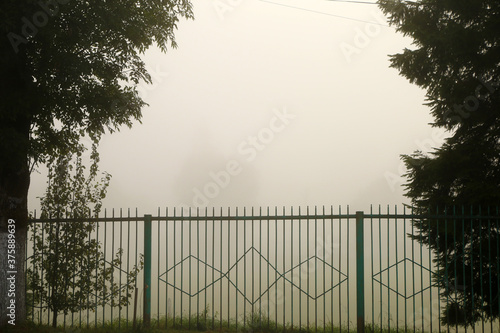 metal fence and thick fog