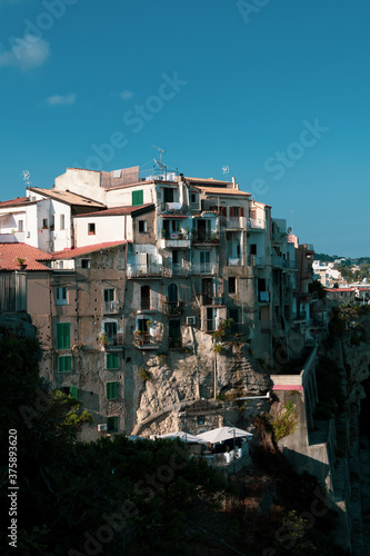 View from above of the vintage buildings of the city center of Tropea, famous touristic destination in the south of italy. Sea view, old discarded buildings and homes. © laura