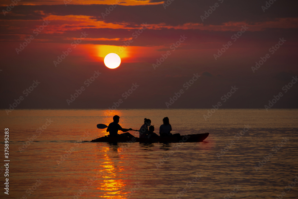 Family kayak in the sunset sea the beauty of nature