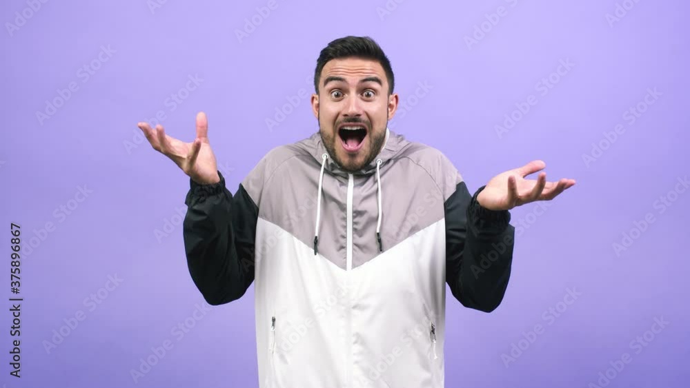Young caucasian man very happy and excited, raising arms, celebrating a victory or success, winning the lottery Young caucasian man very happy and excited, raising arms, celebrating a victory or success, winning the lottery