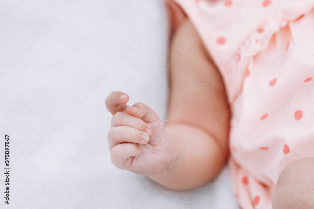 Closeup of newborn baby girl hand on white blanket outdoor. maternity and childhood concept. selective focus Closeup of newborn baby girl hand on white blanket outdoor. maternity and childhood concept. selective focus