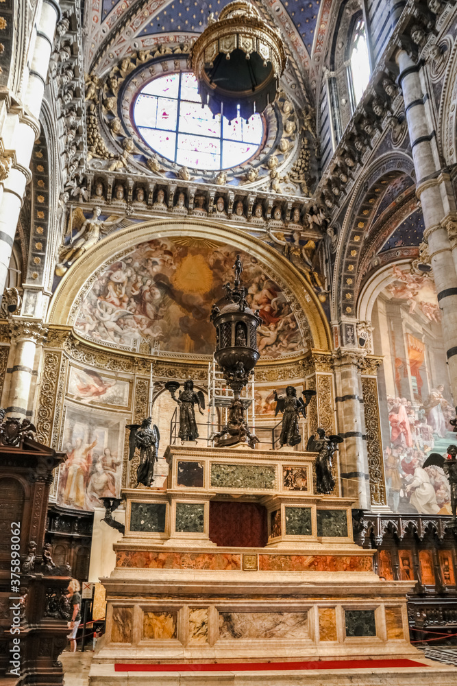 Lovely close-up view of the impressive marble high altar of the presbytery in the Siena Cathedral. It was built in 1532 by Baldassarre Peruzzi. The enormous bronze ciborium is the work of Vecchietta.