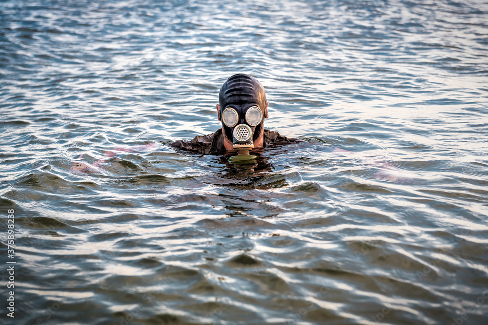 man in rubber gas mask in the sea