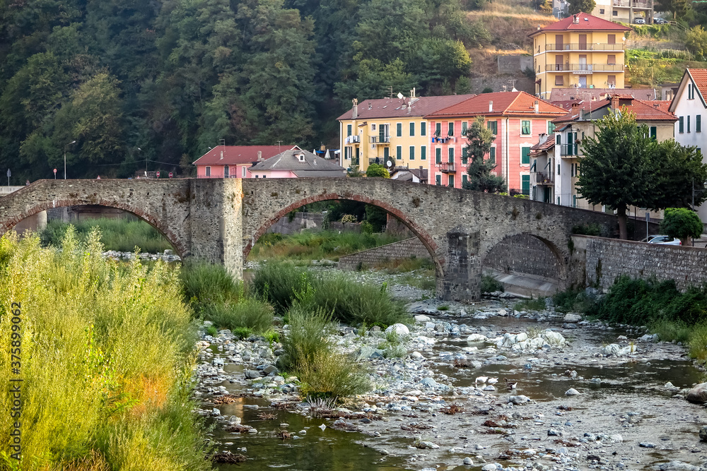 Ancient medieval bridge, in stone arch, over small river, commune of Campo Ligure, Liguria region, Genoa province, Italy