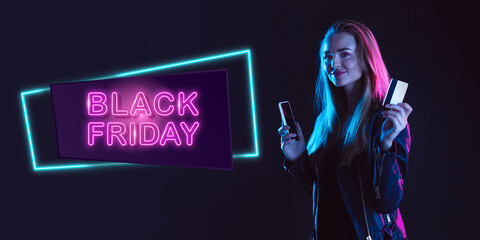 Online shopping. Portrait of young woman in neon on dark studio backgound. Human emotions, black friday, cyber monday, purchases, sales, finance concept. Copyspace. Seamless post for instagram.