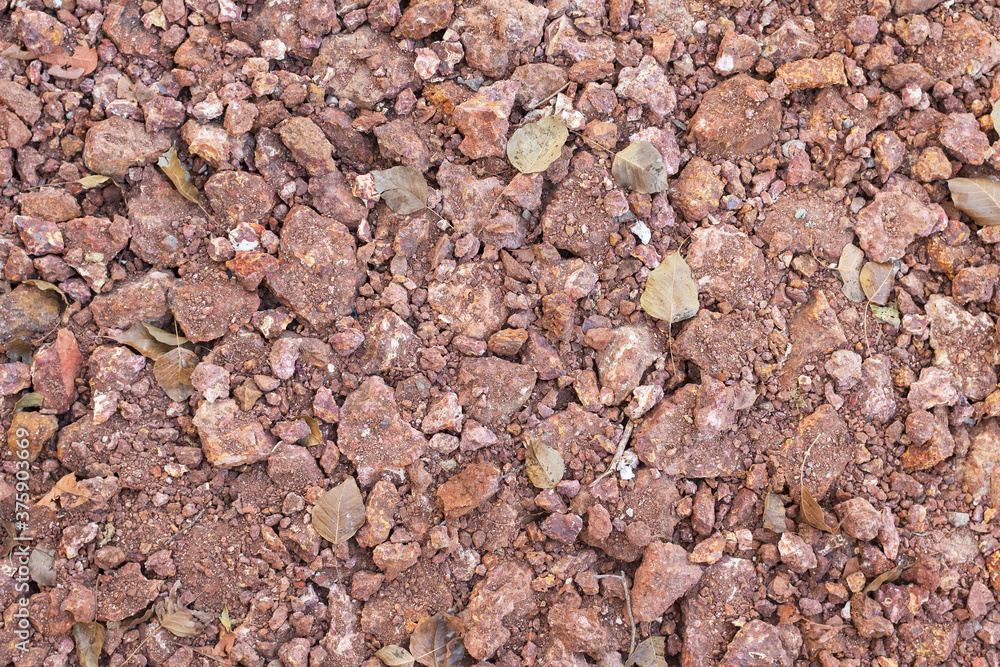 Gravel, a red stone for sidewalks and industry. Gravel, a red stone for sidewalks and industry.