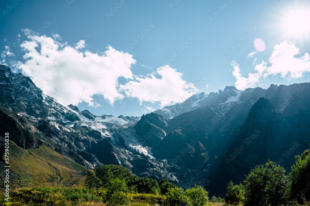 Picturesque scenery. Mountain against cloudy sky. Clouds floating on blue sky over mountain ridge. Picturesque scenery. Mountain against cloudy sky. Clouds floating on blue sky over mountain ridge.