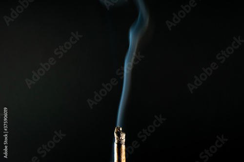 A Smoking Cannabis Cigar on a Black Background