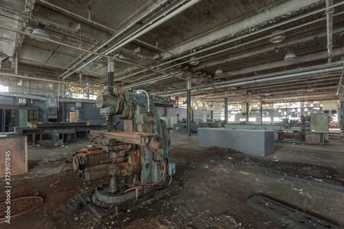 Wide angle shot of industrial machinery in abandoned factory in the deep south