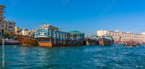 A view of moored dhow cargo vessels and Abra water taxis on the Dubai Creek in the UAE in springtime