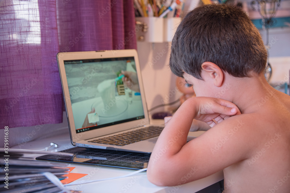 child watching recipes on a laptop computer child watching recipes on a laptop computer