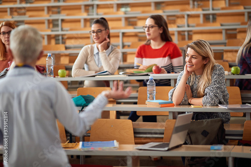 Group of students listening lecture