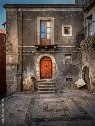 A road in the old medieval town of  Forza D'Agrò, with a stylish and peculiar building. Forza D'Agrò is a little town in Sicily (Italy) with less than 1000 people, where The Godfather 3 was filmed