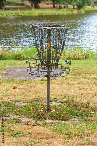 A Frisbee golf hole located near the waters edge