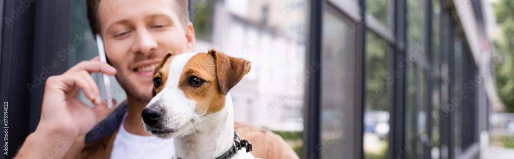website header of man with jack russell terrier dog talking on mobile phone on street website header of man with jack russell terrier dog talking on mobile phone on street