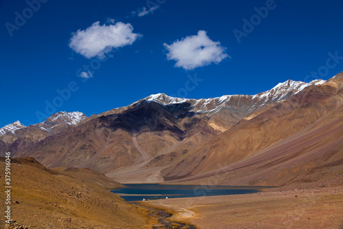Abstract patterns and textures of hills with moderate vegetation, rivers, clouds and clear sky of high altitude cold desert - Spiti Vally. Panoramic views of spectacular landscapes and strange terrain