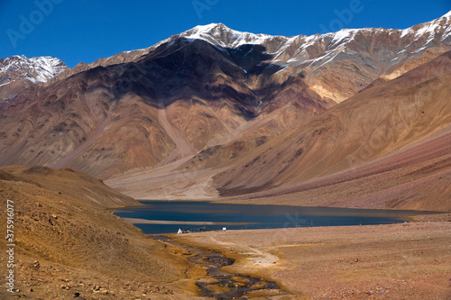 Abstract patterns and textures of hills with moderate vegetation, rivers, clouds and clear sky of high altitude cold desert - Spiti Vally. Panoramic views of spectacular landscapes and strange terrain