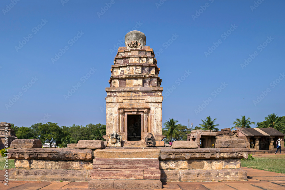 Ancient natural stone temple with clear blue sky background in Aihole, India.
